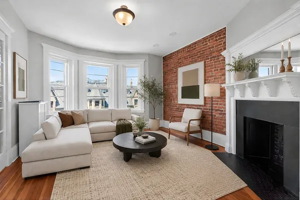 a living room with furniture and a fireplace