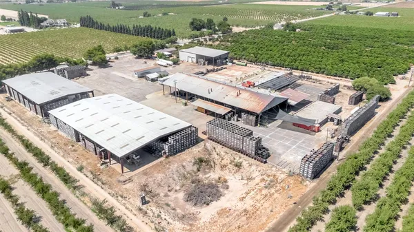 an aerial view of a house with a garden and lake view