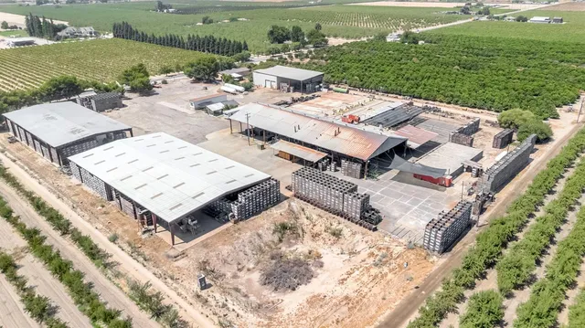 an aerial view of a house with a garden and lake view