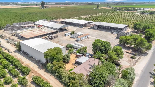 an aerial view of a house with pool a yard and lake view