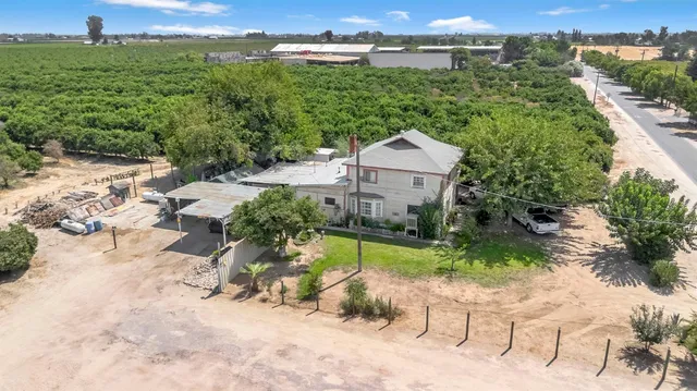 a view of a house with a yard and lake view