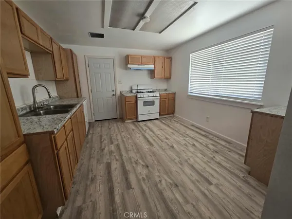 a kitchen with stainless steel appliances granite countertop a sink stove and cabinets