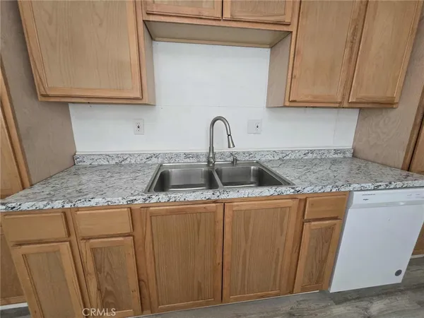 a kitchen with stainless steel appliances granite countertop a sink and cabinets