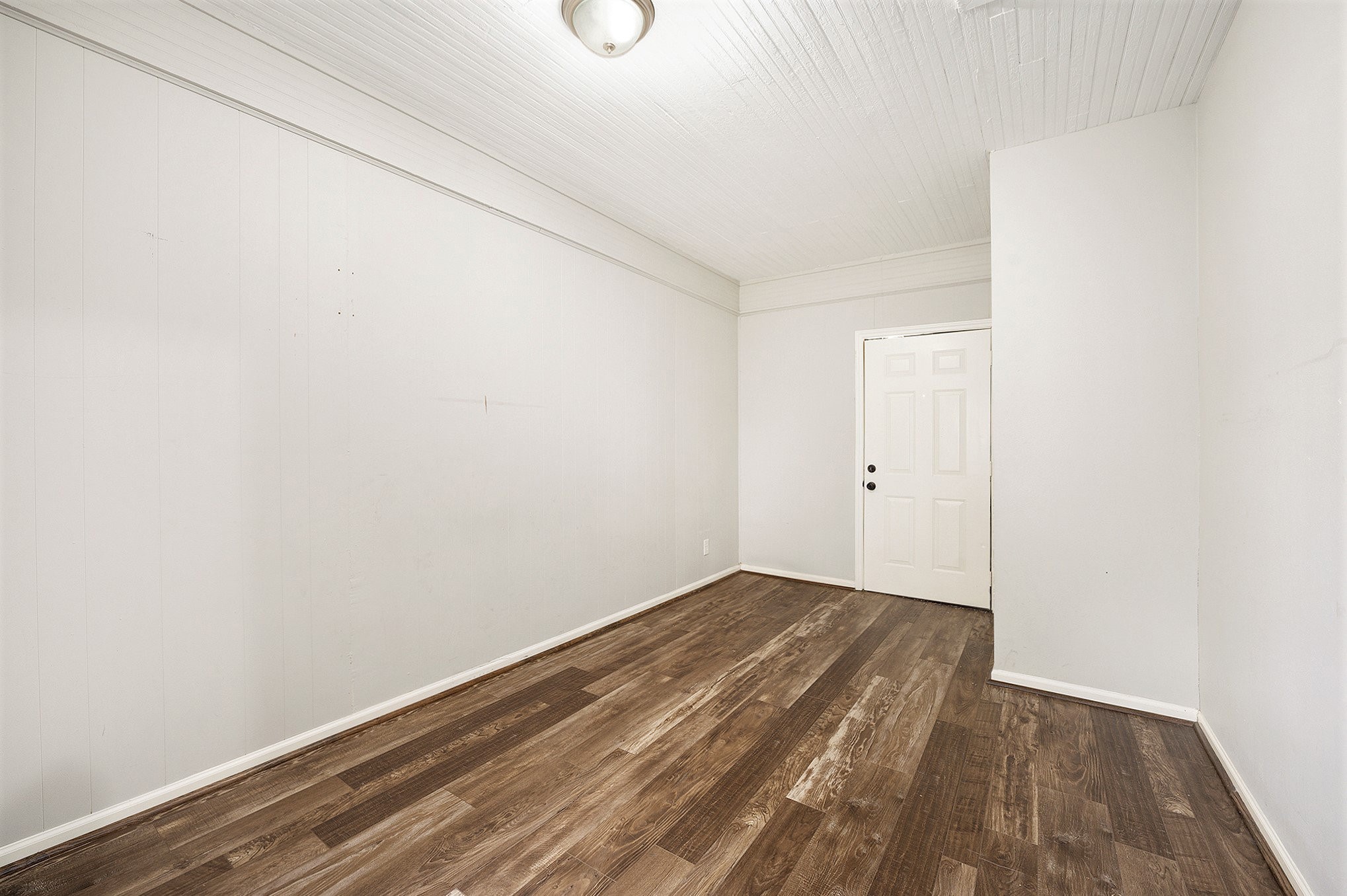10406 Wiggins Street Houston, TX 77029 - Photo 7 of 12 a view of an empty room with wooden floor