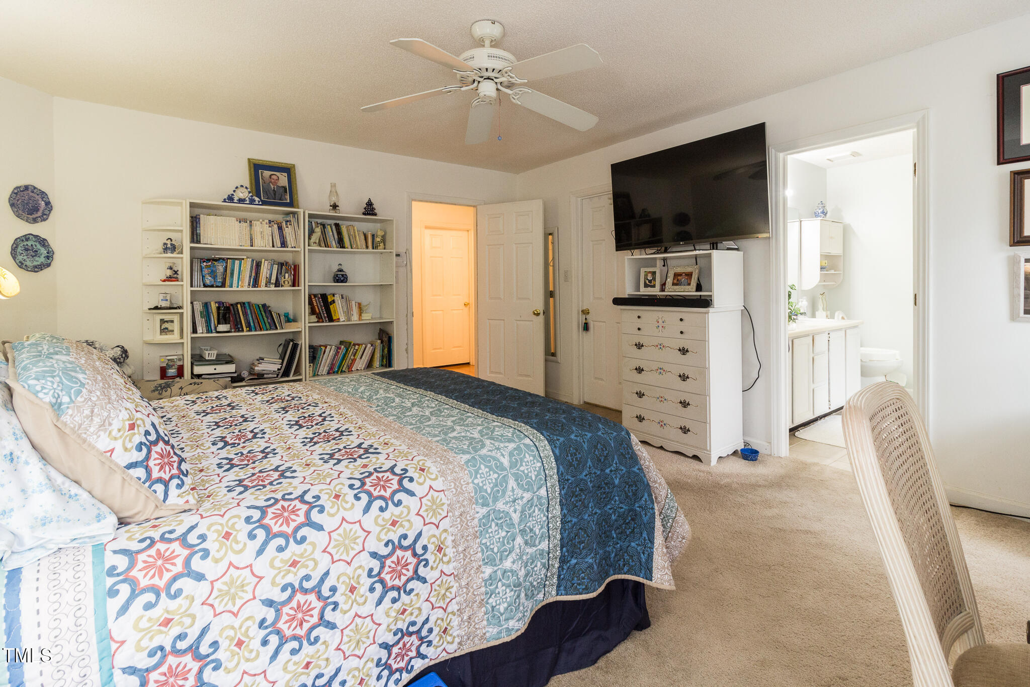 4212 Birmingham Way Raleigh, NC 27604 - Photo 11 of 17 a spacious bedroom with a bed and a flat screen tv