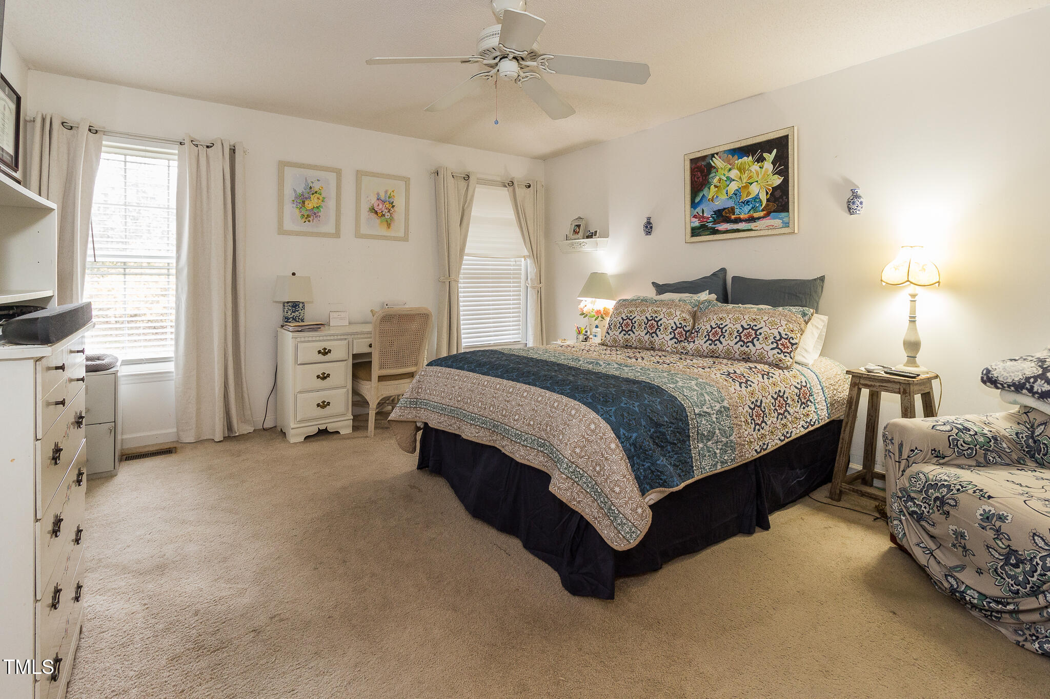 4212 Birmingham Way Raleigh, NC 27604 - Photo 10 of 17 a spacious bedroom with a bed a couch and a window