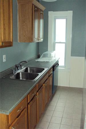 6 Beckman Street Worcester, MA 01607 - Photo 3 of 18 a kitchen with a sink cabinets and window