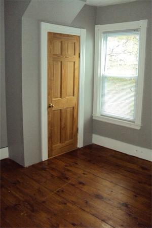 6 Beckman Street Worcester, MA 01607 - Photo 4 of 18 an empty room with wooden floor and a window