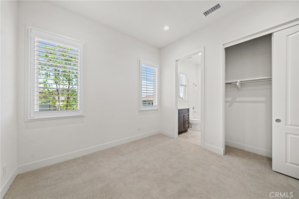 52 Eider Run Irvine, CA 92618 - Photo 15 of 46 an empty room with windows and closet