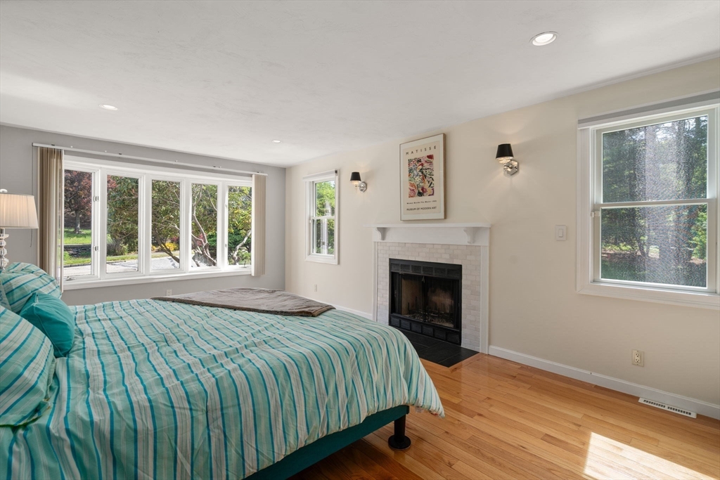 11 Cow Hill Road Sharon, MA 02067 - Photo 18 of 30 a bedroom with a bed and a fireplace