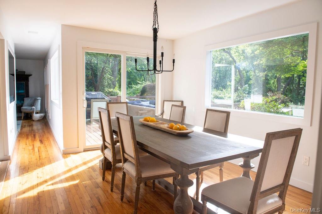 1045 Wagon Wheel Lane Cutchogue, NY 11935 - Photo 12 of 31 a view of a dining room with furniture window and wooden floor