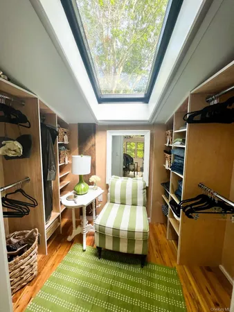 a bathroom with a granite countertop sink a mirror and shower