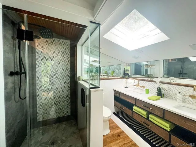 a large white kitchen with a large window