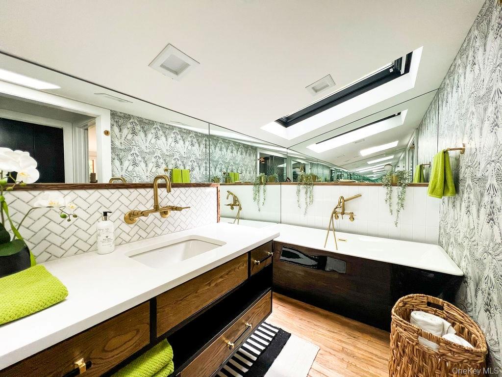 1045 Wagon Wheel Lane Cutchogue, NY 11935 - Photo 22 of 31 a bathroom with a sink and a bathtub