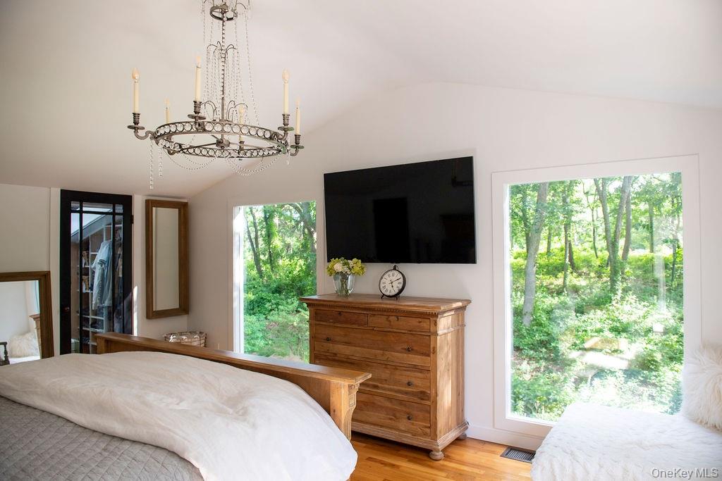 1045 Wagon Wheel Lane Cutchogue, NY 11935 - Photo 24 of 31 a bedroom with furniture flat screen tv and a window