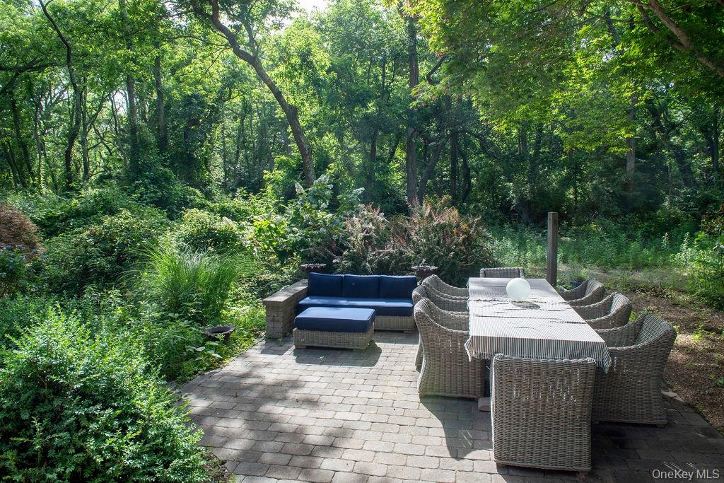 1045 Wagon Wheel Lane Cutchogue, NY 11935 - Photo 28 of 31 a view of an outdoor sitting area with brick walls