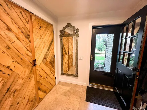 a room with table chairs and window