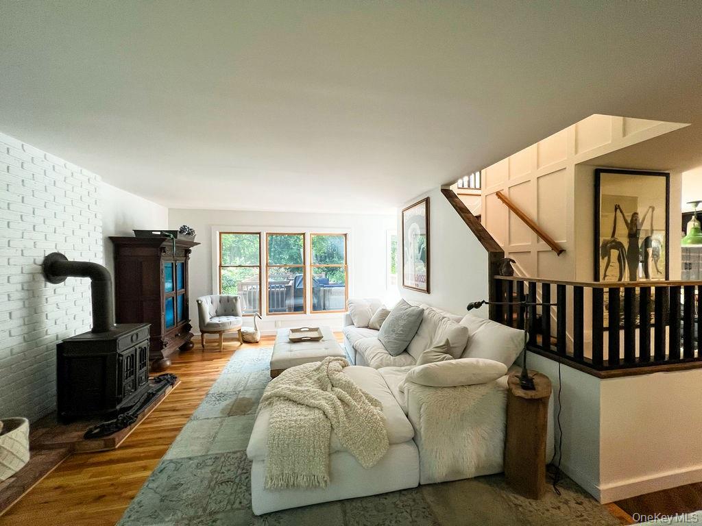 1045 Wagon Wheel Lane Cutchogue, NY 11935 - Photo 6 of 31 a living room with furniture fireplace and flat screen tv