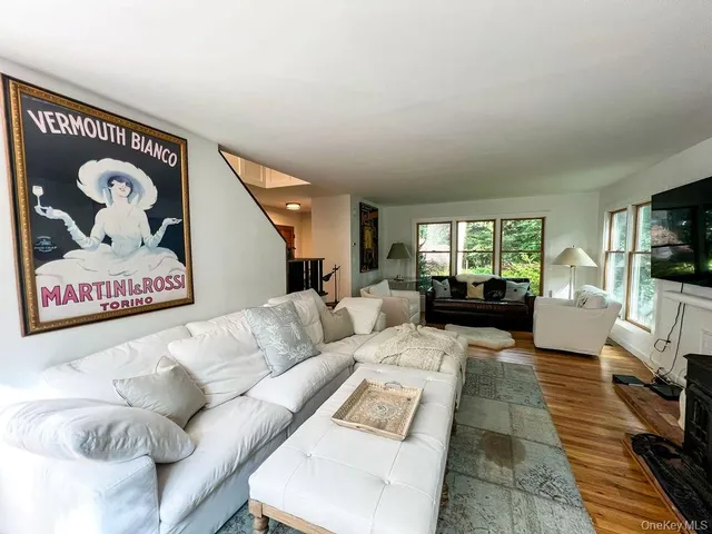 a living room with furniture and a clock