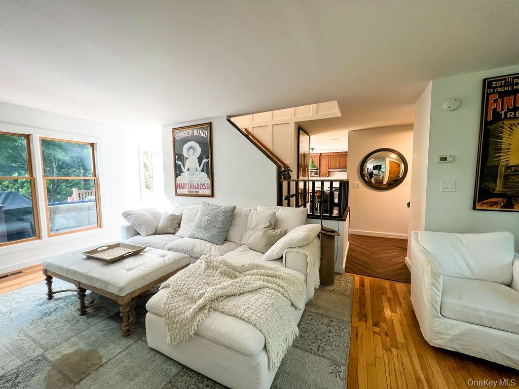 1045 Wagon Wheel Lane Cutchogue, NY 11935 - Photo 8 of 31 a living room with furniture and a clock