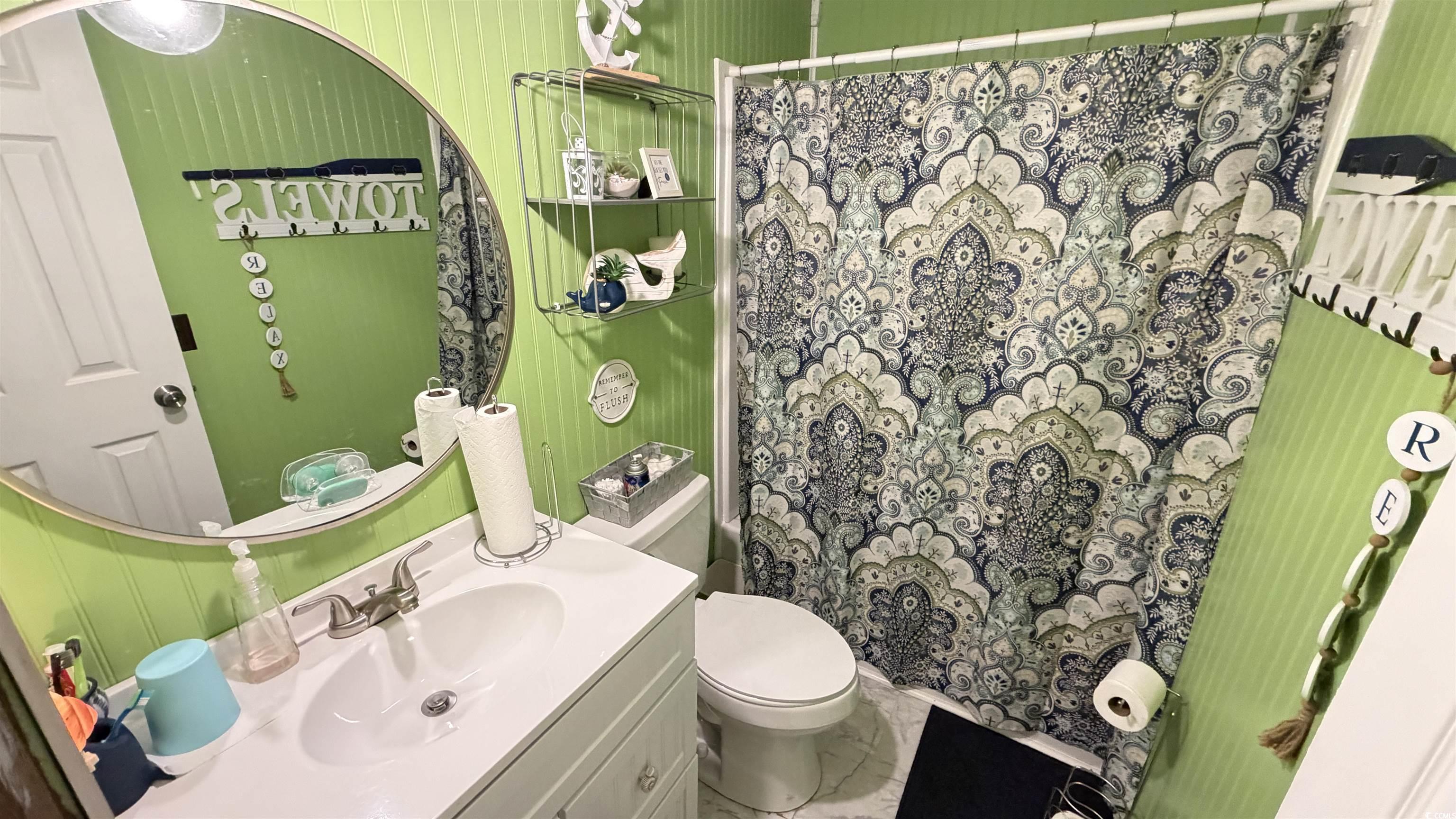 1517 Pisces Lane Myrtle Beach, SC 29575 - Photo 19 of 30 Bathroom with vanity, a shower with shower curtain, and marble look tile flooring