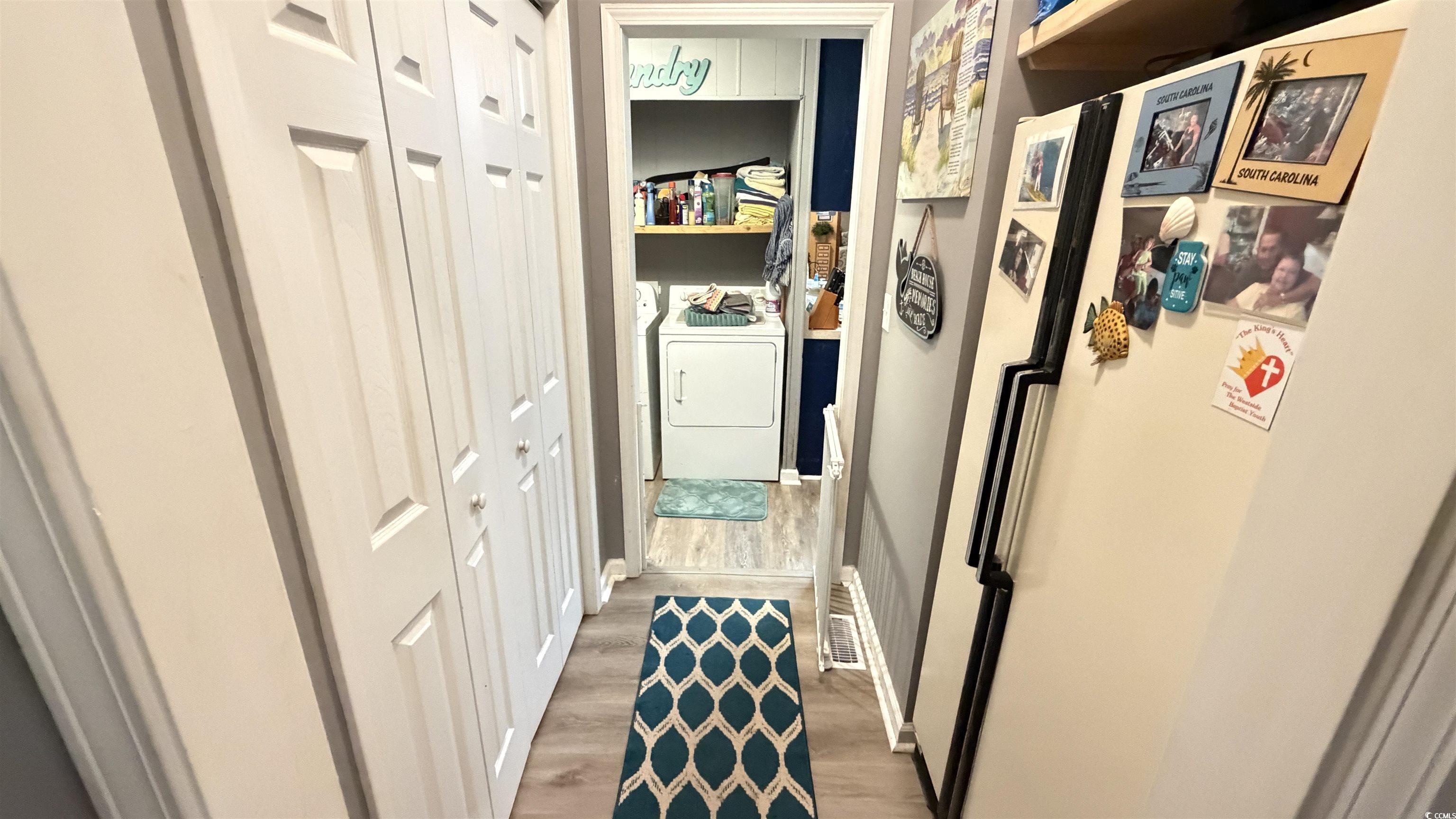 1517 Pisces Lane Myrtle Beach, SC 29575 - Photo 21 of 30 Hall featuring light wood-style flooring and washing machine and clothes dryer