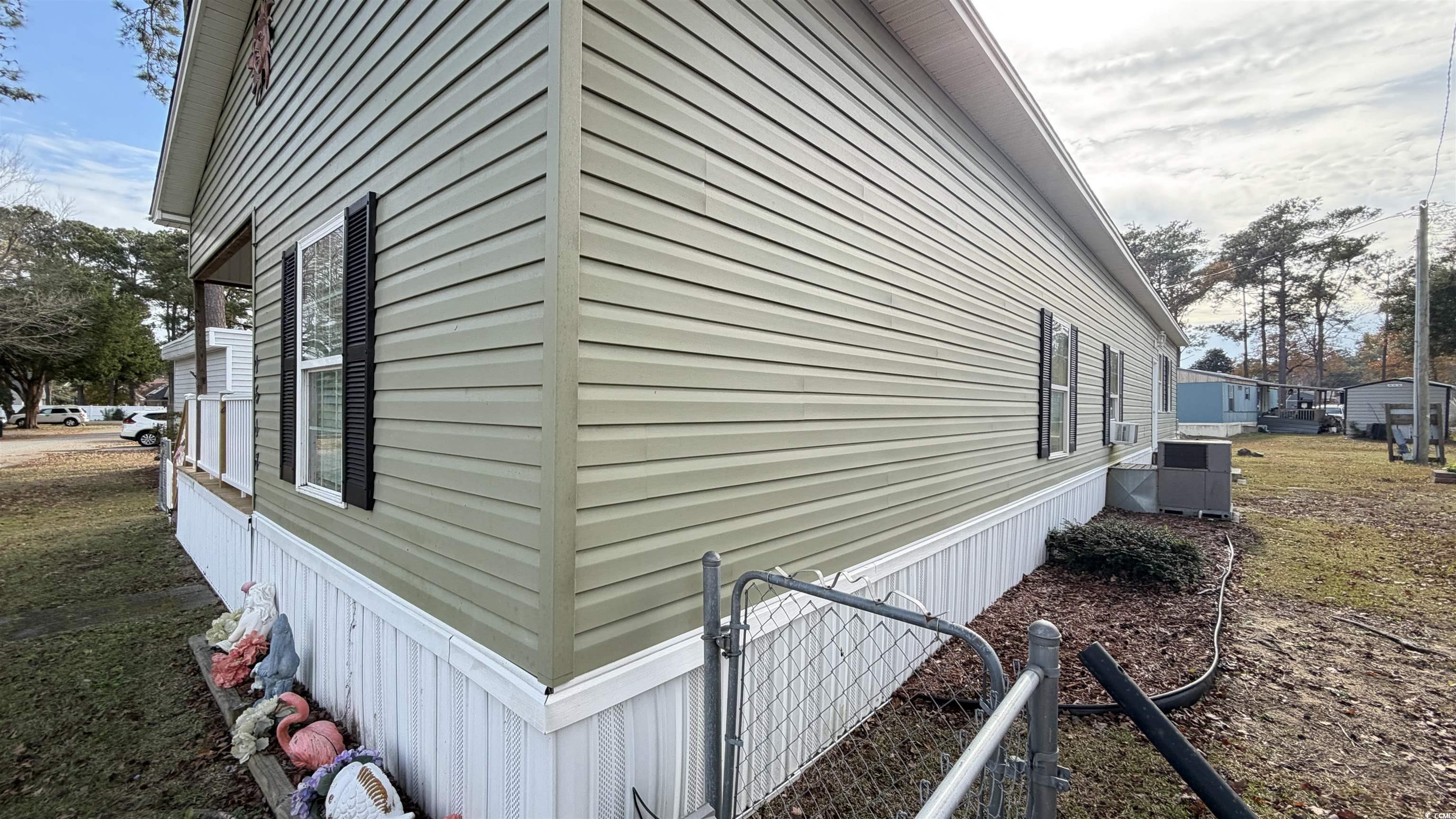 1517 Pisces Lane Myrtle Beach, SC 29575 - Photo 28 of 30 View of home's exterior with cooling unit and a central air condition unit