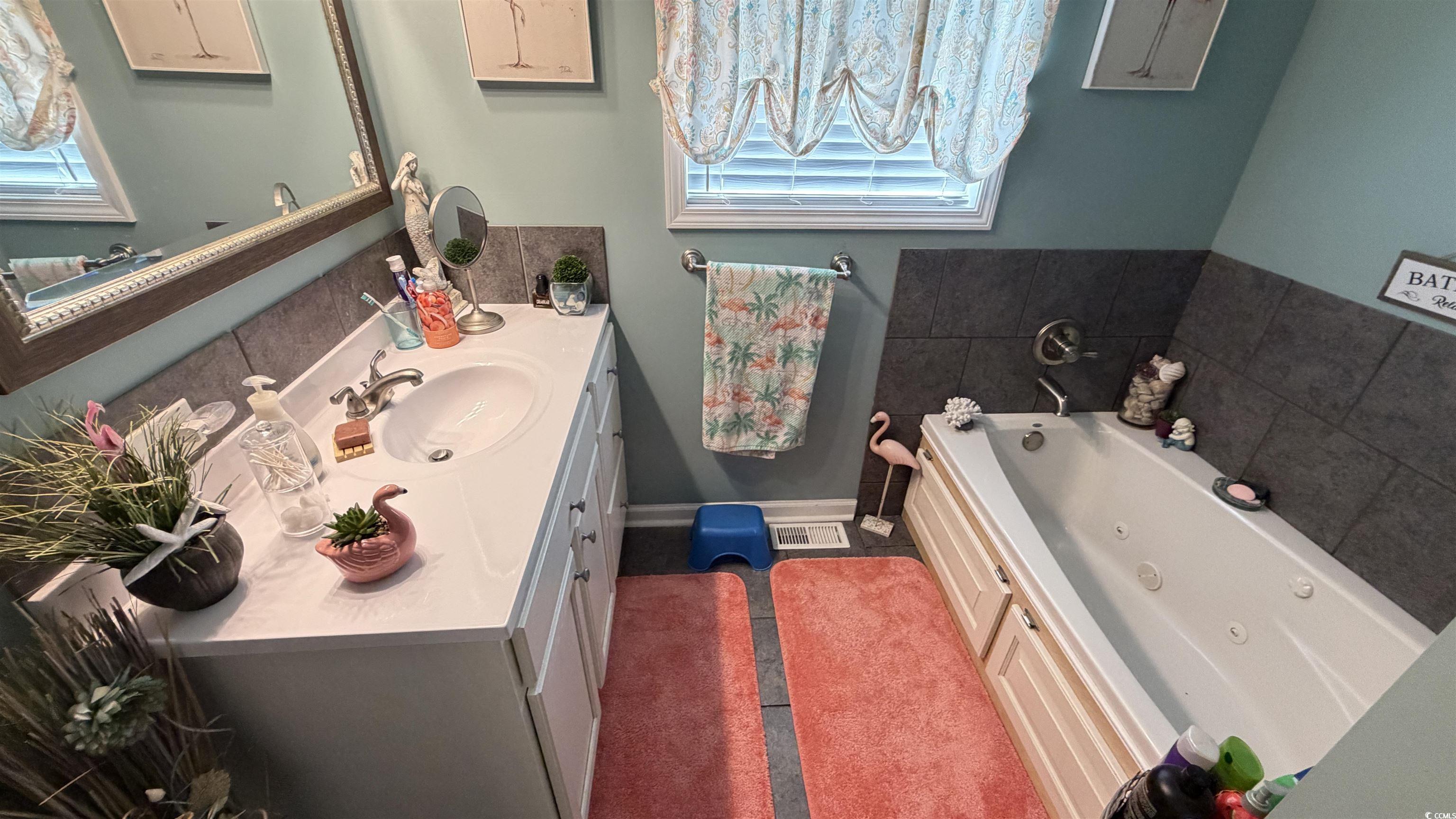 1517 Pisces Lane Myrtle Beach, SC 29575 - Photo 10 of 30 Bathroom with vanity and a tub with jets