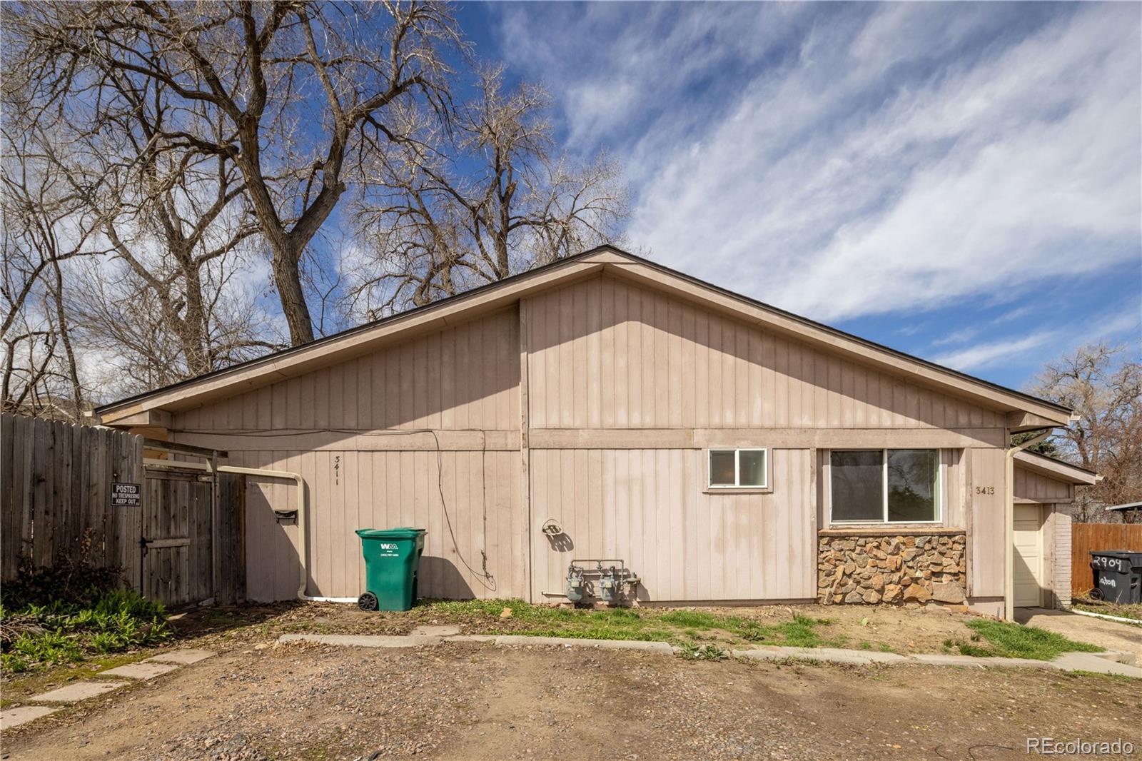 a view of a house with wooden fence