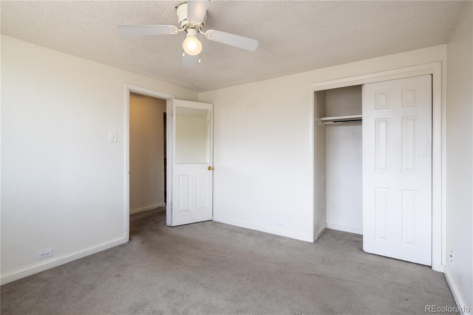 3413 Wadsworth Boulevard Wheat Ridge, CO 80033 - Photo 12 of 25 an empty room with a ceiling fan and a window