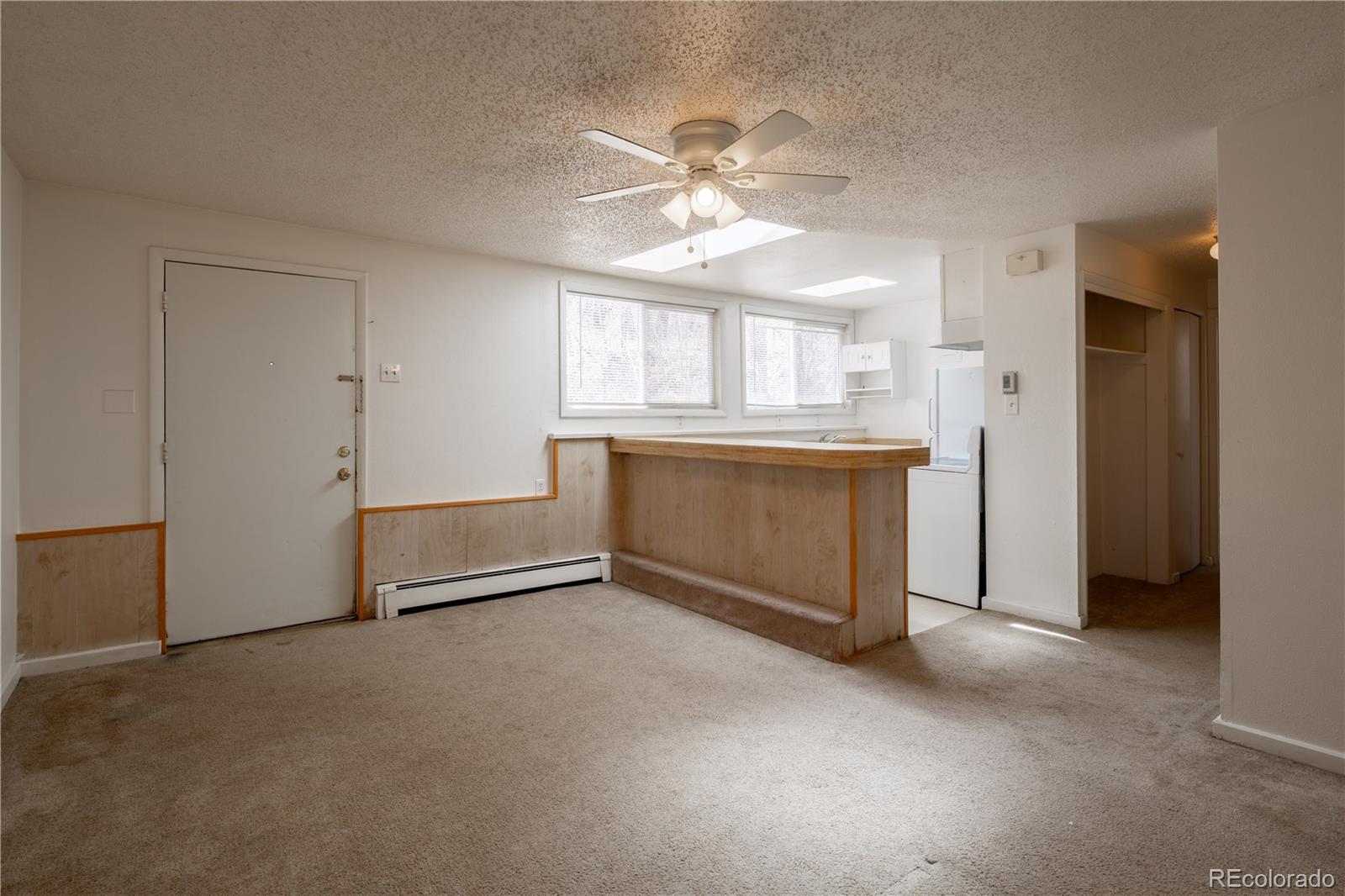 3413 Wadsworth Boulevard Wheat Ridge, CO 80033 - Photo 18 of 25 an empty room with windows and fan