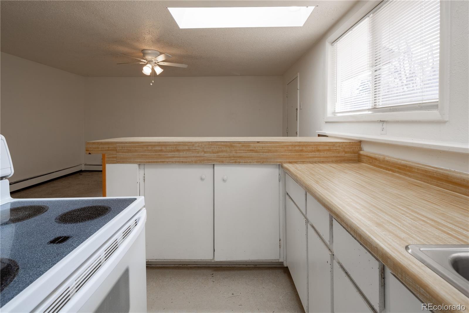 3413 Wadsworth Boulevard Wheat Ridge, CO 80033 - Photo 20 of 25 view of kitchen with granite countertop cabinets