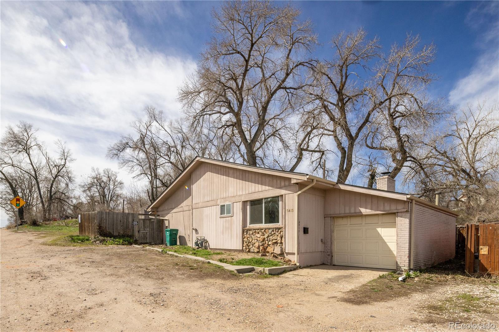 3413 Wadsworth Boulevard Wheat Ridge, CO 80033 - Photo 2 of 25 a view of a house with a yard covered in snow