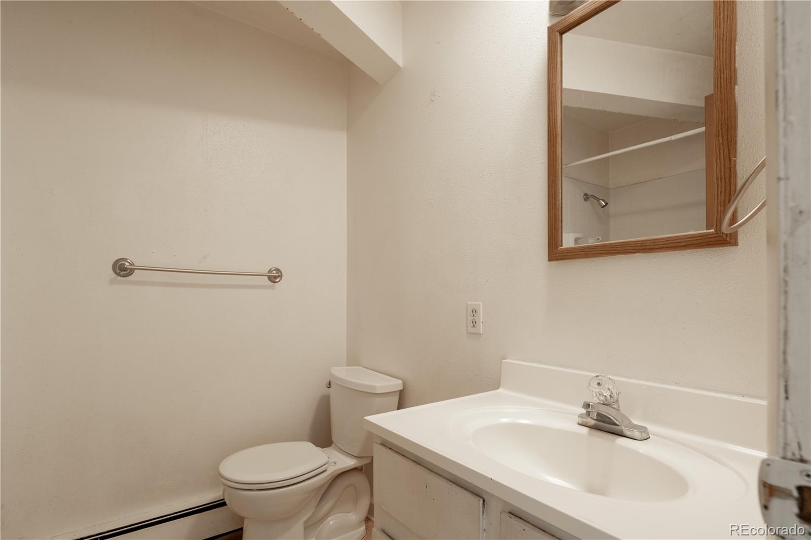 3413 Wadsworth Boulevard Wheat Ridge, CO 80033 - Photo 24 of 25 a bathroom with a sink toilet and a mirror