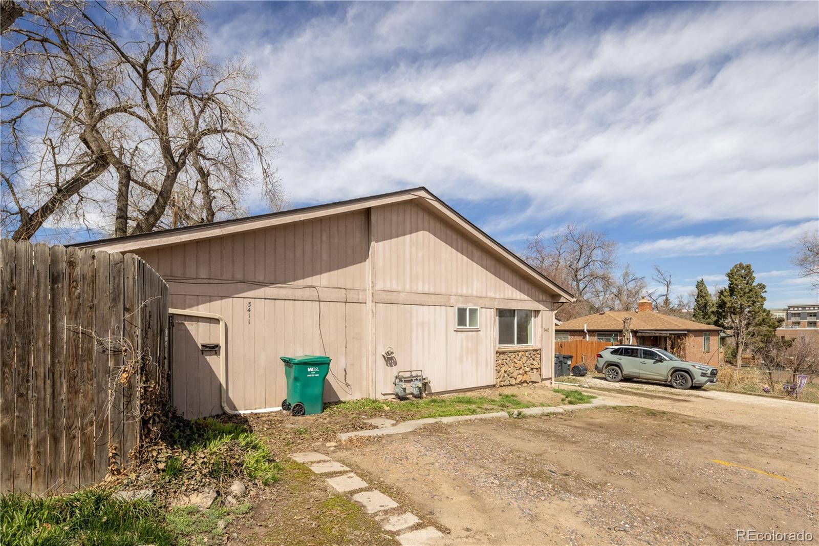 3413 Wadsworth Boulevard Wheat Ridge, CO 80033 - Photo 3 of 25 a view of a house with a backyard and garage