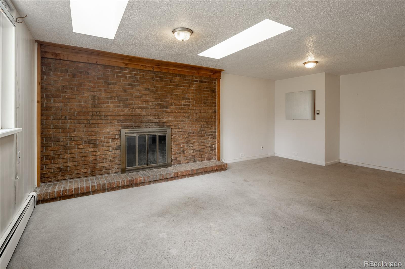 3413 Wadsworth Boulevard Wheat Ridge, CO 80033 - Photo 4 of 25 a view of empty room with a fireplace