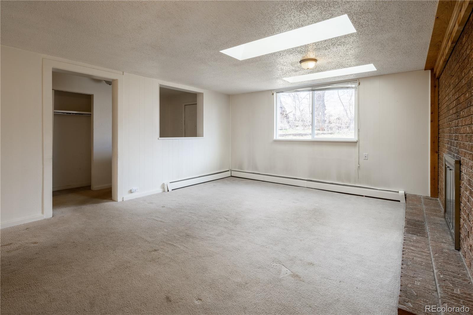 3413 Wadsworth Boulevard Wheat Ridge, CO 80033 - Photo 6 of 25 an empty room with windows and closet