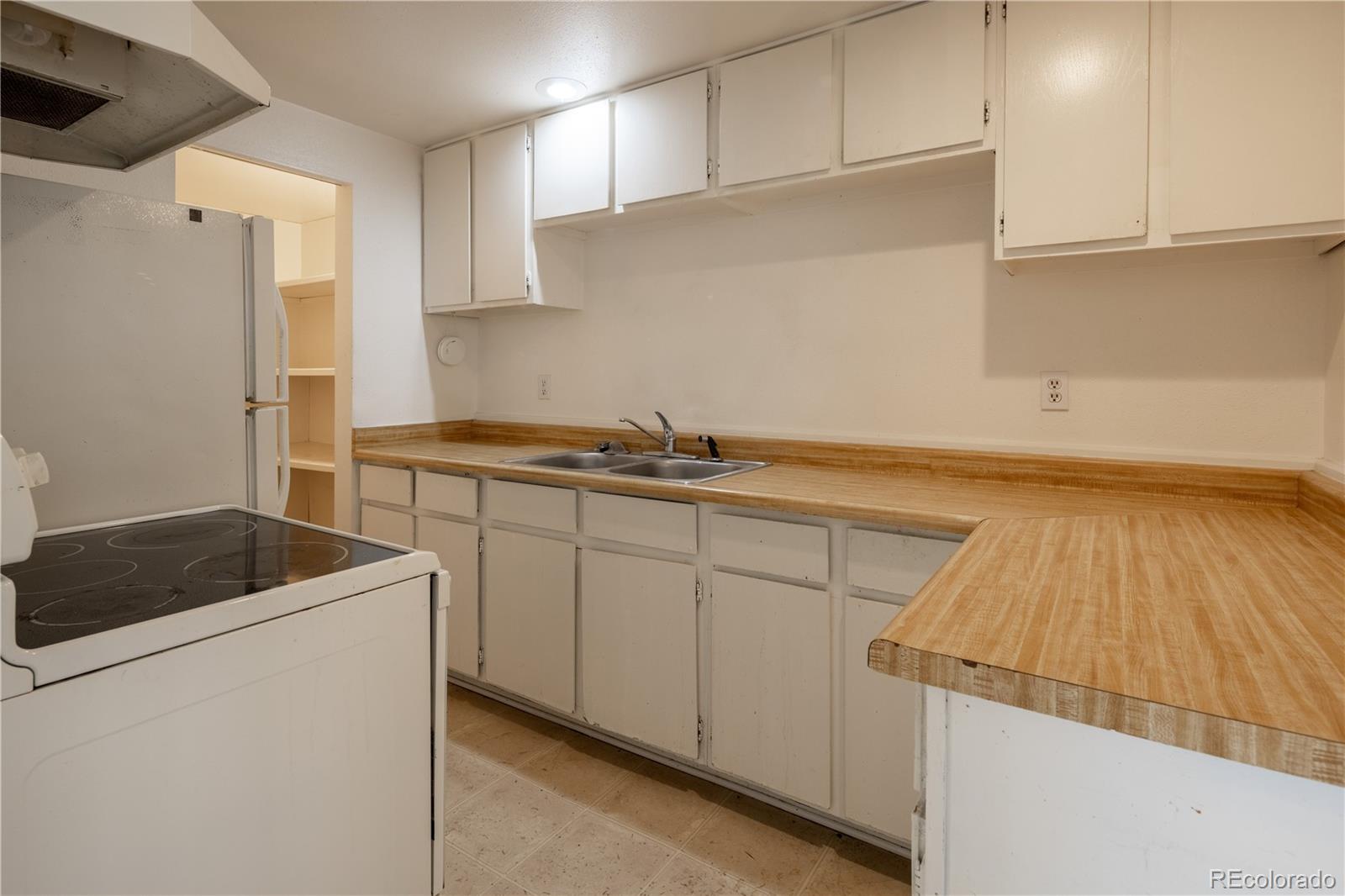 3413 Wadsworth Boulevard Wheat Ridge, CO 80033 - Photo 8 of 25 a kitchen with a sink and cabinets