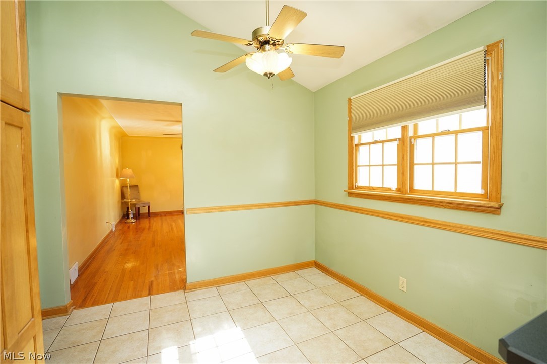 453 Omar Street Struthers, OH 44471 - Photo 18 of 27 Empty room featuring light tile patterned floors, lofted ceiling, and ceiling fan