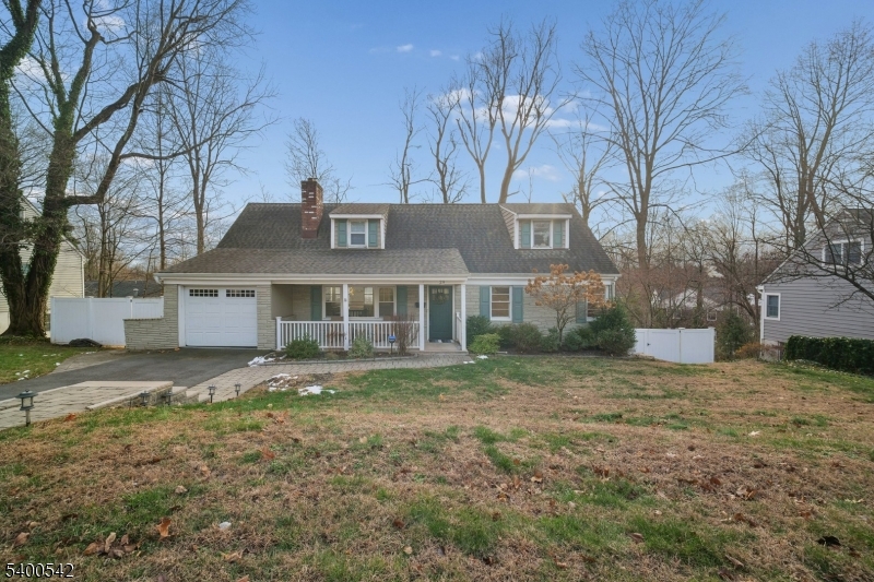 a view of a big house with a yard and large tree