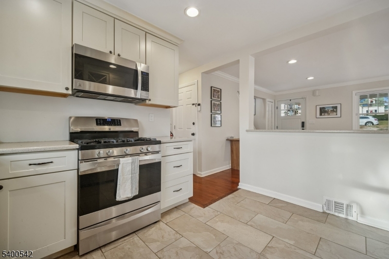 29 Washington Avenue Morristown, NJ 07960 - Photo 12 of 31 a kitchen with stainless steel appliances granite countertop white cabinets a sink a stove a microwave and a refrigerator