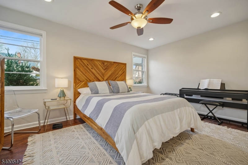 29 Washington Avenue Morristown, NJ 07960 - Photo 16 of 31 a bedroom with a bed and a chandelier