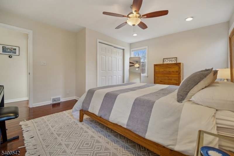 29 Washington Avenue Morristown, NJ 07960 - Photo 17 of 31 a bedroom with a large bed and a chandelier
