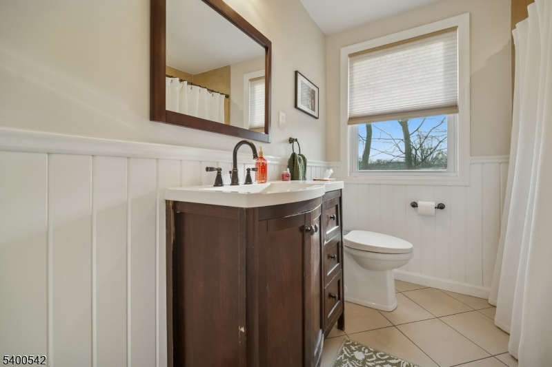 29 Washington Avenue Morristown, NJ 07960 - Photo 20 of 31 a bathroom with a toilet sink and mirror