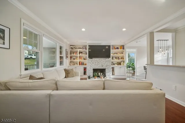 a living room with furniture a flat screen tv and a fireplace