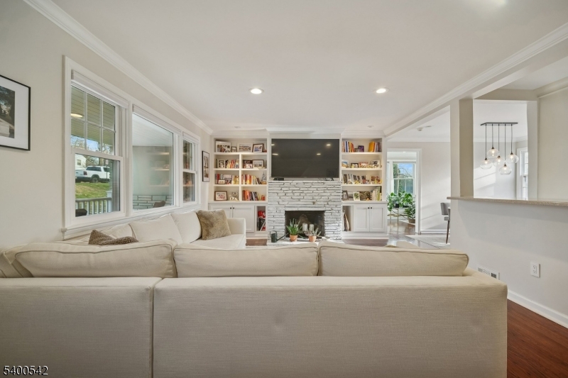 29 Washington Avenue Morristown, NJ 07960 - Photo 5 of 31 a living room with furniture a fireplace and a flat screen tv