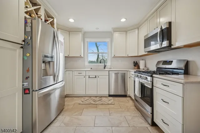 a kitchen with a refrigerator sink and cabinets