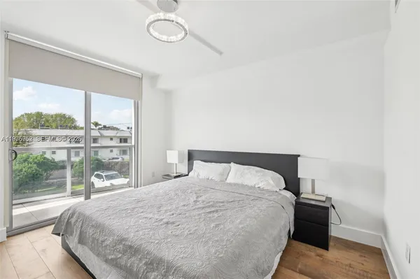 a large bed sitting in a bedroom next to a window