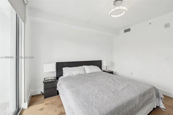 a bedroom with a bed and a table