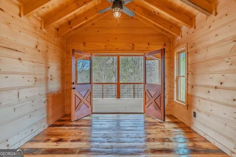 a view of a hallway with wooden floor and a fireplace